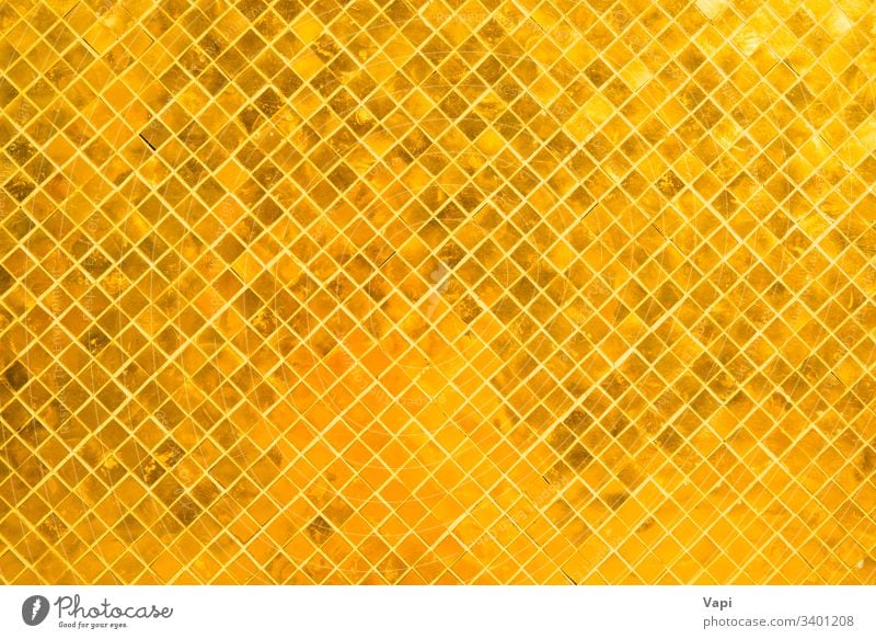 Closeup view of many gold shiny squares surface texture abstract background pattern mosaic design wallpaper backdrop color interior modern tile golden