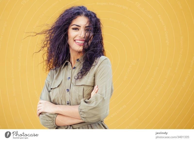Young Arab woman with curly hair outdoors Woman Hair Curly hairstyle Smiling Beautiful Girl Beauty & Beauty youthful Fashion copyspace Middle East Yellow Green