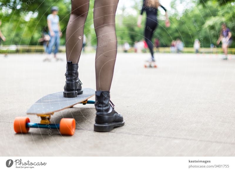 Girl wearing black boots and stockings practicing long board riding in skateboarding park. Active urban life. Urban subculture. sport one lifestyle fun skater