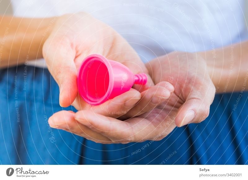 Woman holding a pink menstrual cup in hands. Closeup zero waste woman product look menstruation hygiene reusable silicone alternative care clean eco female