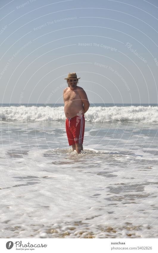 young man on a beach Man vacation Summer Swimming trunks Ocean Atlantic Ocean Sandy beach wide holidays Tourist Holidaymakers Summer vacation Waves