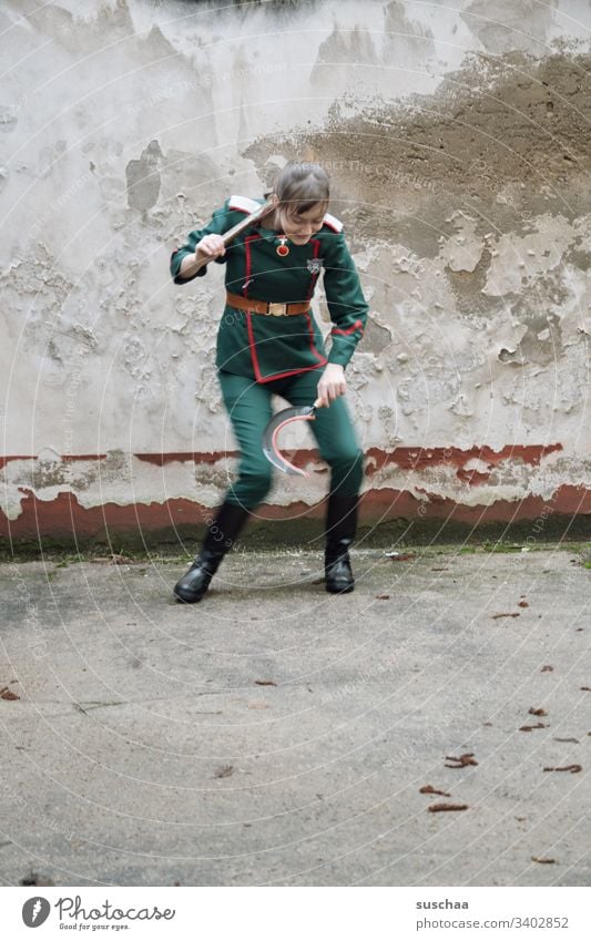 youth in uniform with sickle and hammer in hand makes a strange dance Girl Young woman Youth (Young adults) teenager Puberty Uniform Suit Hammer Tool