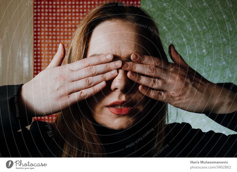 Woman abused face covered with hands abused woman abusing adult afraid background black casual caucasian concept dark emotion expression eyes fear female girl