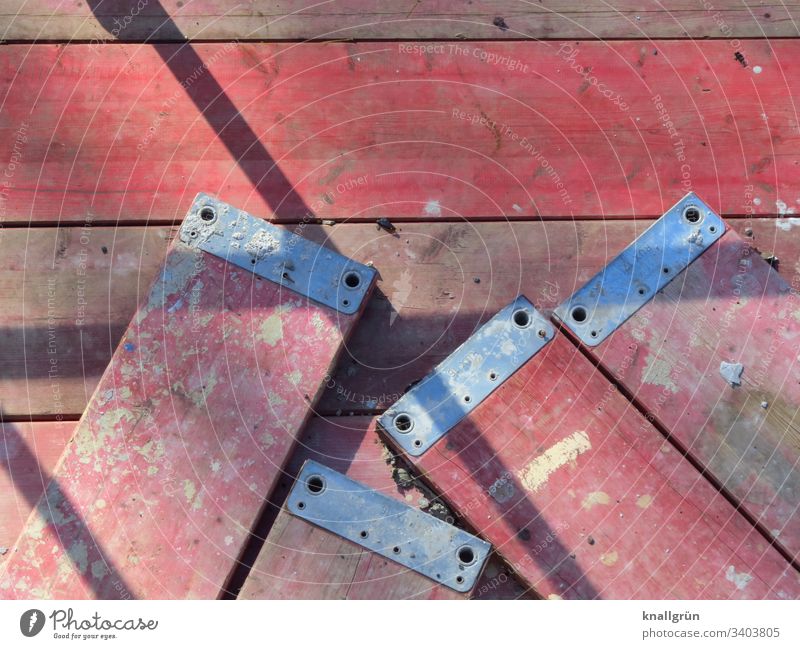 Sloping red scaffold planks Scaffolding planks Red Construction site Exterior shot Colour photo Deserted Work and employment Light Shadow reclining obliquely