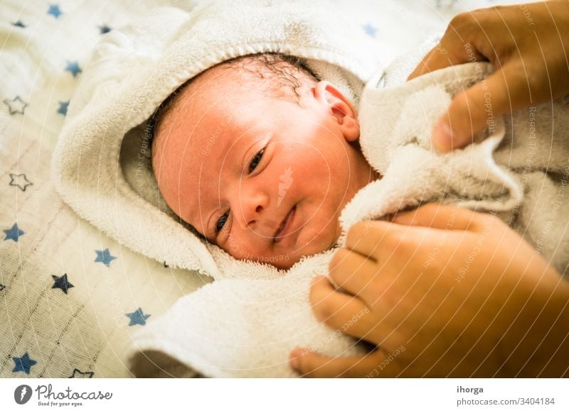 newborn baby at the time of his bath adorable beautiful blanket blue boy care caucasian cheerful child childhood clean closeup comfortable cute emotion