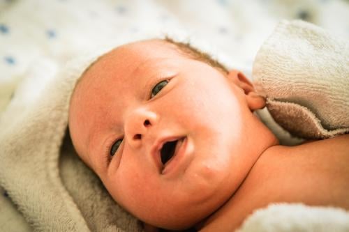 newborn baby at the time of his bath adorable beautiful blanket blue boy care caucasian cheerful child childhood clean closeup comfortable cute emotion