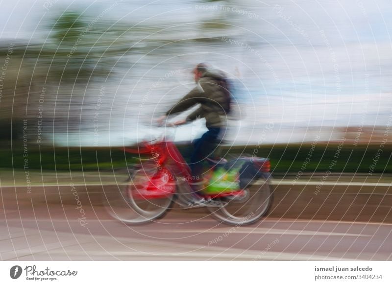 man ciclyng on the street in Bilbao city Spain, mode of transport cyclist biker bicycle transportation cycling biking exercise ride speed fast blur blurred