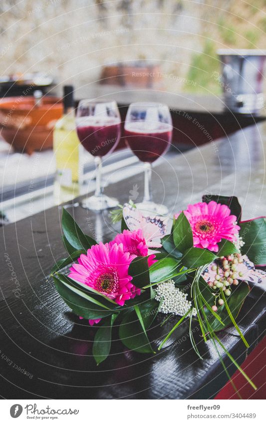 Film photo of a bouquet of flowers and two wine cups wedding romantic outdoors outside blank pink union decoration property green atrezzo empty celebration