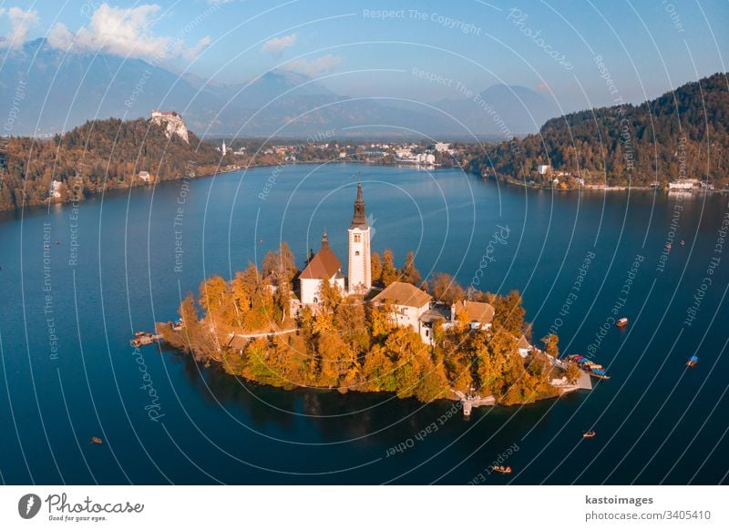Aerial view of Bled island on lake Bled, and Bled castle and mountains in background, Slovenia. slovenia bled scenic landmark church julian water scenery europe
