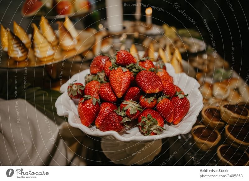 Plate with strawberries on banquet table strawberry celebrate dish reception event sweet food plate fresh dessert fruit yummy wedding organic tasty delicious