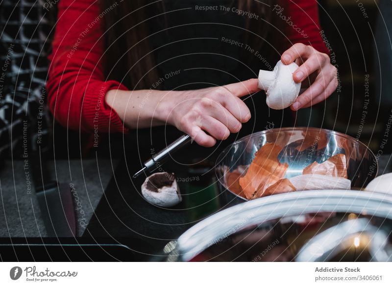 Crop woman cutting mushroom over bowl kitchen course clean cook restaurant table knife female prepare food lesson school modern fresh lady slice cafe cafeteria