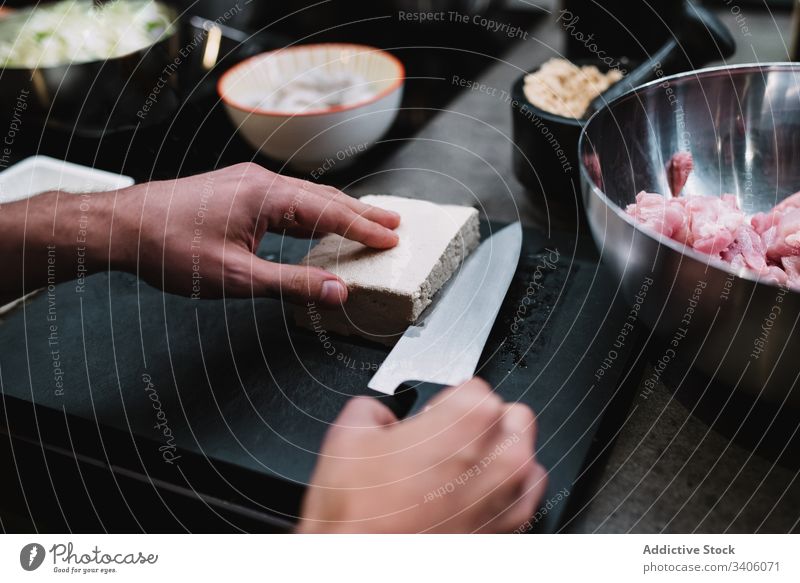 Crop person slicing cheese in restaurant kitchen cut chef cook lesson bowl meat food ingredient bread meal culinary recipe prepare table cuisine fresh work job