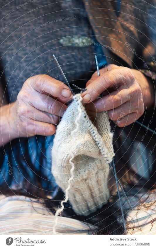 Crop senior woman knitting garment yarn natural needle warm wool elderly hobby female tradition handmade craft material rustic thread handicraft lady apparel