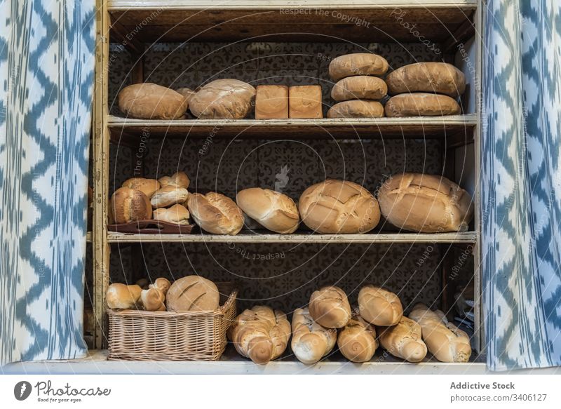 Fresh bread on shelves in bakery shelf sell assorted fresh food rustic loaf pastry baked organic arrangement natural tasty delicious gourmet composition curtain