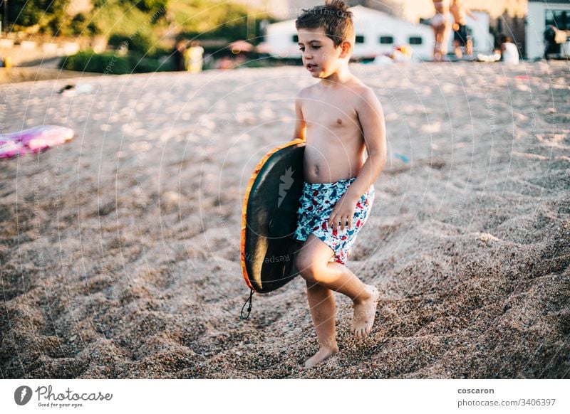 Little boy with a surfboard on the beach active caucasian child childhood coast colorful cute enjoying fun happiness happy kid kite leisure lifestyle little
