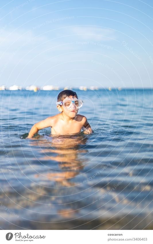 Funny kid with diving goggles on the beach active activity blue boy cheerful child childhood cute diver expressive fun happiness happy holiday holyday joy laugh
