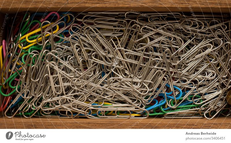 Close up of paper clips in a wooden box organization steel nobody chrome fastener close-up wire iron color togetherness supply multi stationery connection group