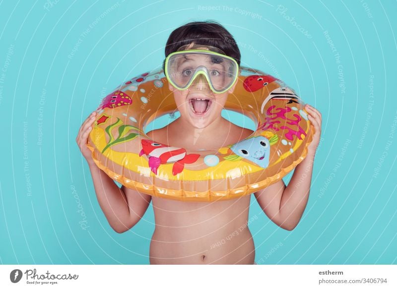 Funny child smiling with float ring summer pool cheerful joy happy happiness holidays lifestyle expression relax smile swimsuit swimming inflatable travel trip
