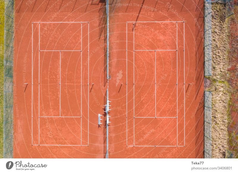 tennis court from above sport sports tennis courts ash orange white lines sun shadow summer winter sharp tennis net tennis nets ball balls tennis ball trees