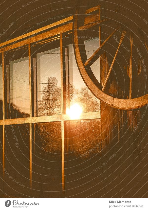 The last evening hours in the window of a woodshed. *Evening sun *reflection *window pane *light *romantic *Wood *Wheel *House *Sentiment *Sun *Evening *Warm