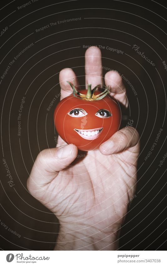 Tomato with face in hand Red Nutrition Vegetarian diet Vegan diet Face eyes Mouth Hand Smiling Vegetable Healthy Eating Food Food photograph fun Funny Humor