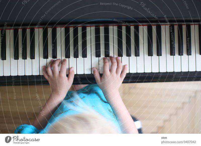 Child practicing piano Piano Music Concentrate Play piano Musical instrument Make music Keyboard instrument Musician Leisure and hobbies Interior shot fumble