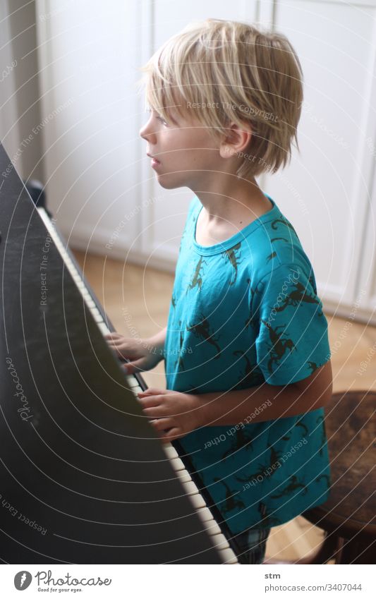boy plays piano Piano Boy (child) Music Grand piano classical music music education tool Make music Musical instrument Play piano Keyboard Leisure and hobbies