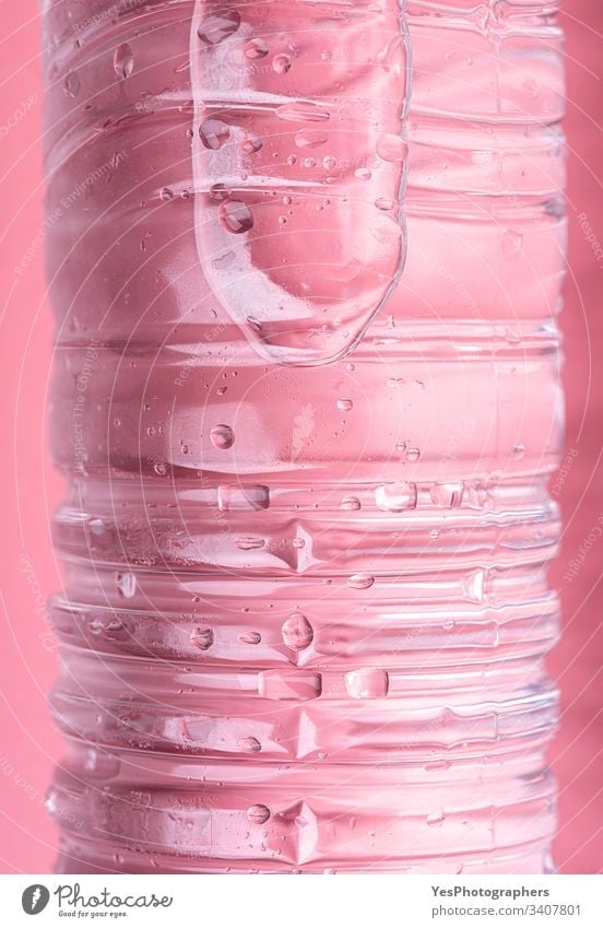 Water bottle on pink background close-up aqua beverage clear cold cool details drink ecology energy fresh frost liquid macro plastic pure purity recycle
