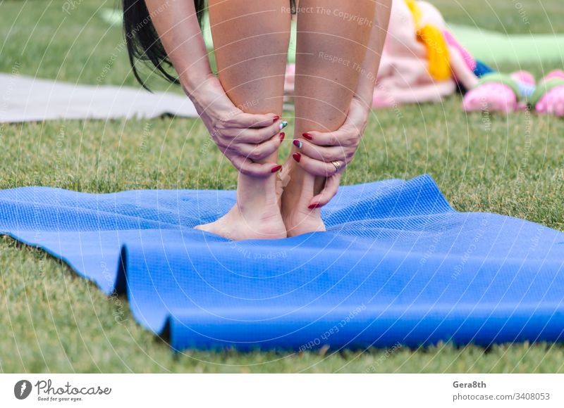 female legs on yoga mat close up active asana carimat city color colored day exercise fingers fresh grass green group group class hands health healthy lifestyle