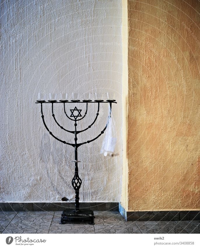 Menorah, misused menorah Menorah-im Candlestick Judaism symbol Interior shot Stand Metal forged Art Star of David Wall (barrier) Wall (building) floor Deserted