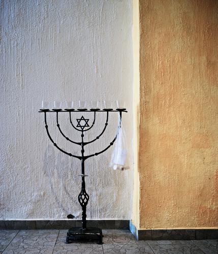 Menorah, misused menorah Menorah-im Candlestick Judaism symbol Interior shot Stand Metal forged Art Star of David Wall (barrier) Wall (building) floor Deserted