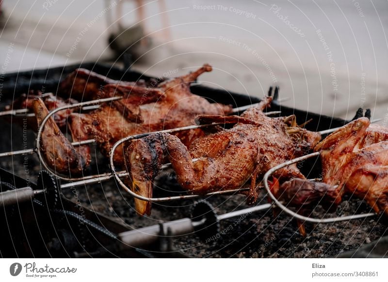 Whole crispy roasted ducks on skewers on a grill Barbecue (apparatus) grilled Crisp speared grill skewer Delicious Meat Eating Food Colour photo Grill entirely