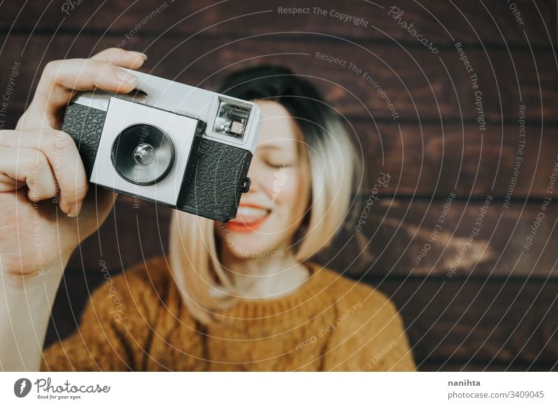 Young woman taking photographies with an analog camera vintage photography photographer cool trendy retro young youth artits fresh freshness ombre style
