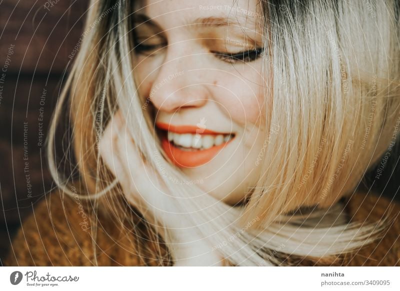 Close up of a beautiful young and cool woman emotion pretty face youth hairstyle modern casual blonde trendy fresh freshness happy sensual caucasian white
