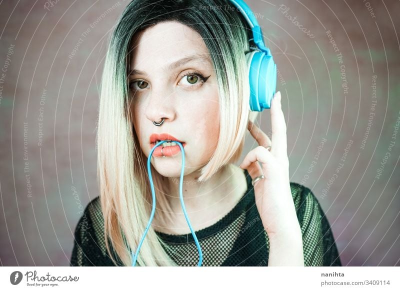 Young modern woman listening to music technology enjoy fresh headphones piercing headset cool freshness youth hobby leisure time portrait portraiture people