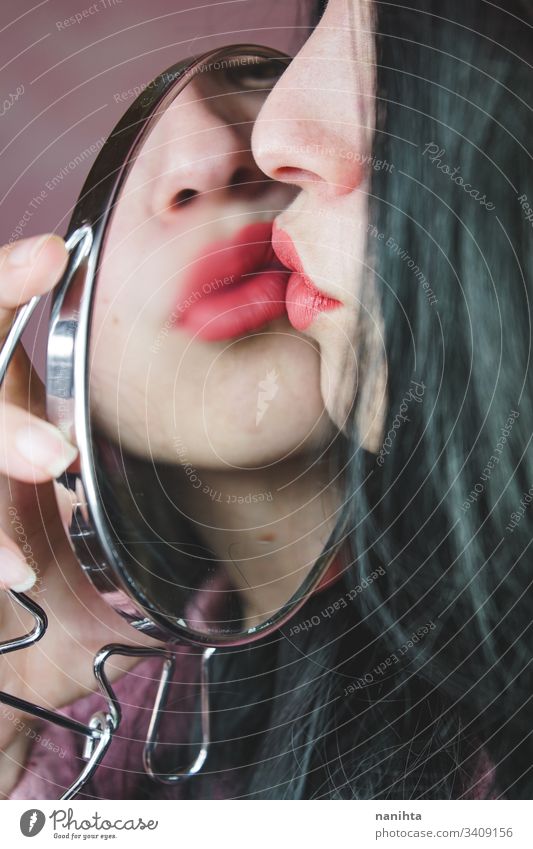 Close up of a beautiful woman reflected in a mirror beauty cosmetics lipstick close up young fashion trendy cool reflection brunette sensual face pretty youth