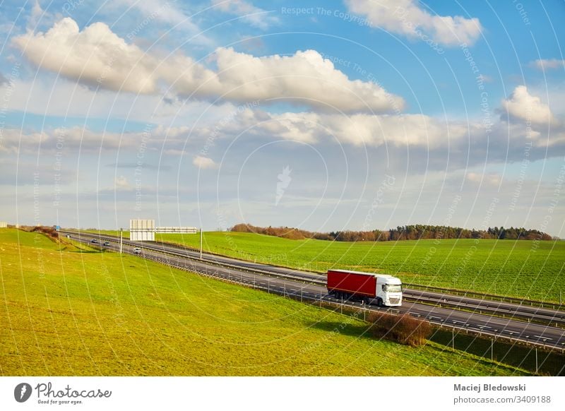 Rural landscape with a highway in the spring. truck transport road outdoors supply chain logistics lorry drive trailer transportation vehicle shipping