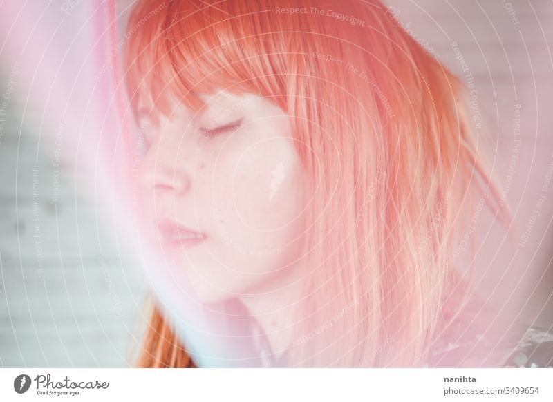 Romantic and dreamy portrait of a redhead woman young blur blurry effect creative creativity pastel tones pretty face mood moody daydream daydreamer art