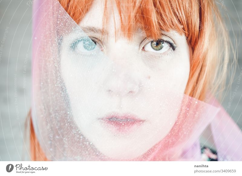 Romantic and dreamy portrait of a redhead woman young blur blurry effect creative creativity pastel tones pretty face mood moody daydream daydreamer art