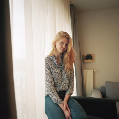 Portrait of a young woman beside the window at the curtain Woman Girl Blonde Beautiful youthful Slim daintily Elegant Lifestyle dwell Flat (apartment) at home
