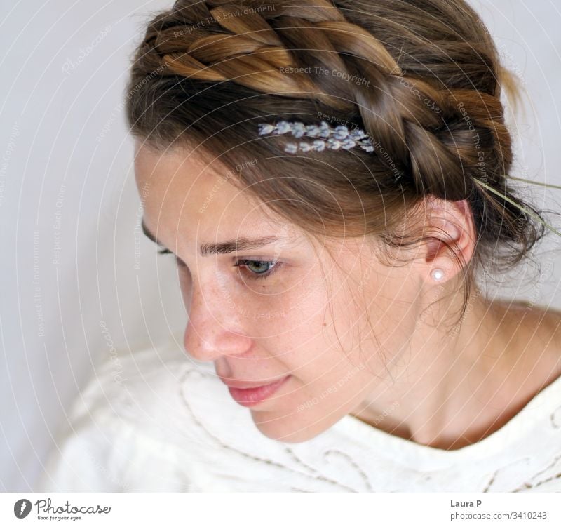 Young smiling woman with braided hair, dressed in white young face natural look close up portrait green eyes peaceful nice beautiful beauty fresh silent