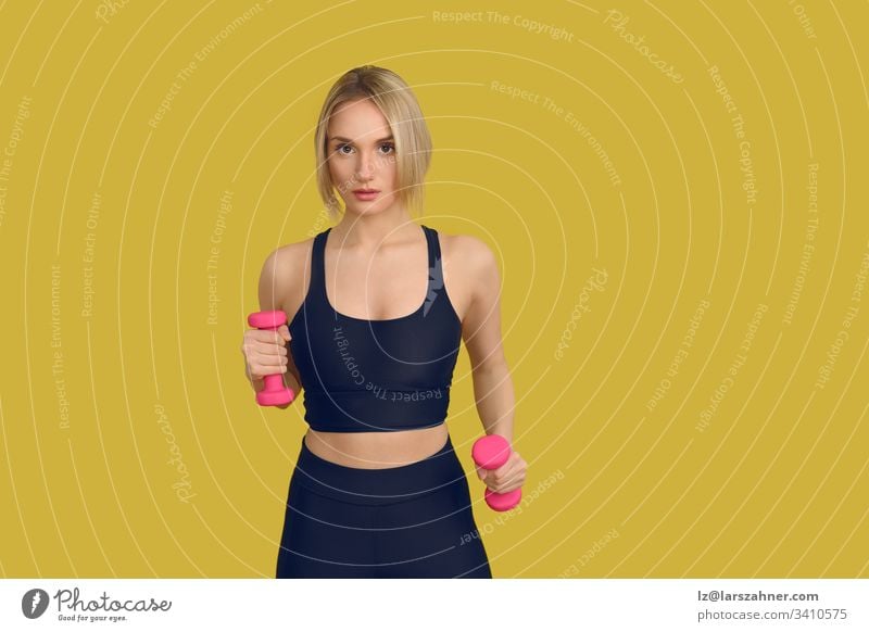 Pretty blonde woman with pink dumbbells Close-up active Attractive Beautiful Black Blonde Body Cute Dumbbells tutorial Fitness Front side Gymnastics hands