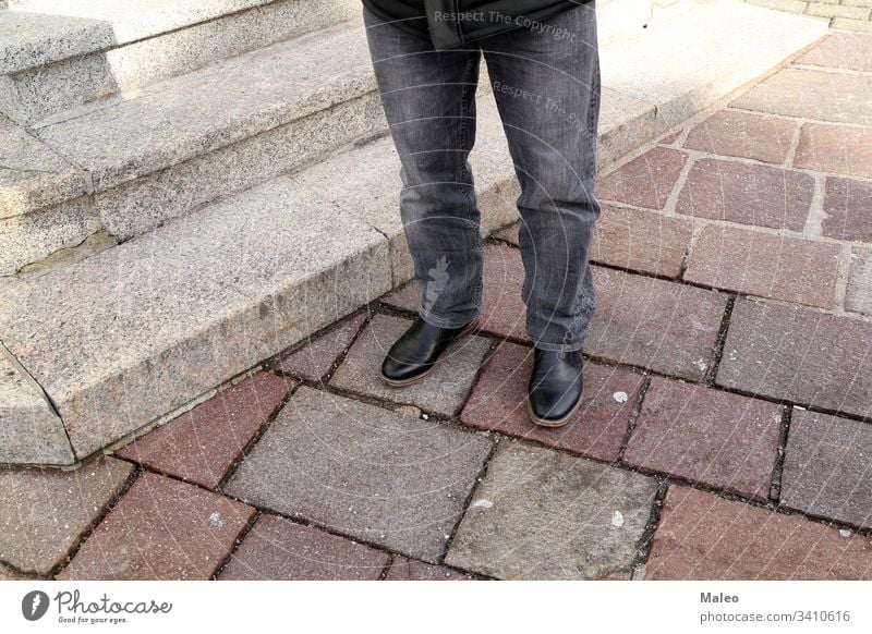 Legs in jeans and black shoes at the granite steps fashion foot footwear legs style urban beautiful city close female girl gray leather stone street walk woman