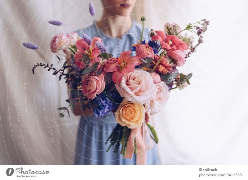 Young woman in a light blue dress holding a bouquet of flowers. Romantic concept. girl soft light beautiful vintage wedding white young beauty happy pink cute