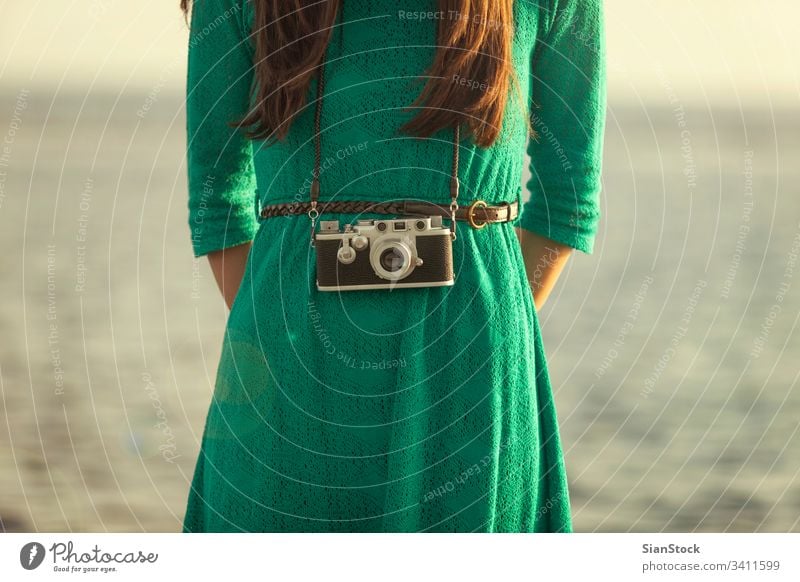 Vintage photo, brunette girl with retro camera beach vintage ocean vacation people summer travel blue photographer fashion lifestyle holiday funky women