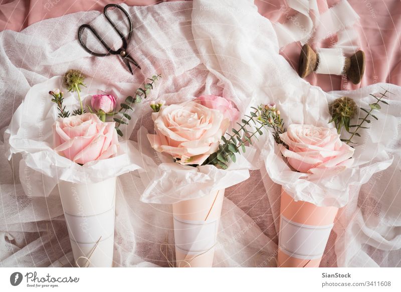 Bouquets of flowers  in  paper cones white cornets rose roses pastel background bouquet isolated valentine day pink green spring floral summer top beautiful
