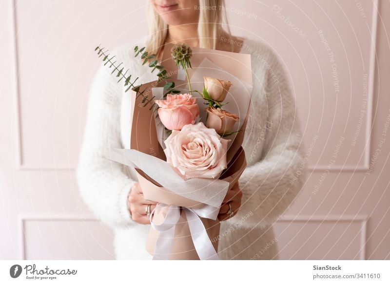 Woman holding a bouquet of roses flowers hand woman beautiful background floral white gift giving fresh spring female pink day beauty paper love green blossom