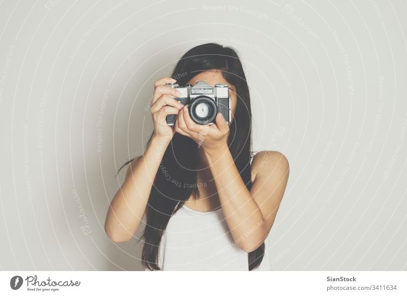 Woman take picture with a vintage old camera background white woman isolated retro female photography portrait beautiful lifestyle photographer person