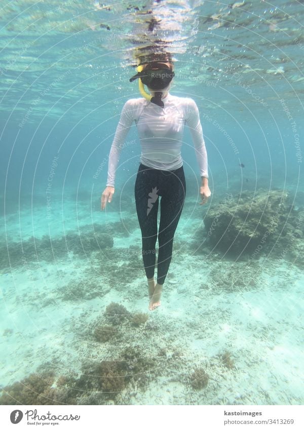Woman with mask snorkeling in blue sea. woman water underwater tropical clear fun ocean dive female lifestyle summer young marine face goggles leisure holiday