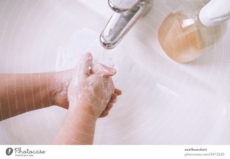 washing hands with soap and water in sink or hand basin hygiene bathroom health personal body care clean sanitary healthcare closeup close-up unrecognizable